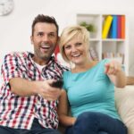 couple-sitting-couch-watching-funny-movie-min-150x150.jpg