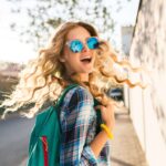 cool-stylish-smiling-happy-blond-woman-walking-street-with-backpack-min-150x150.jpg