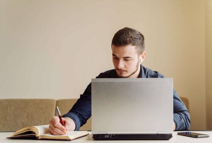 Young man studying the Hindi alphabet