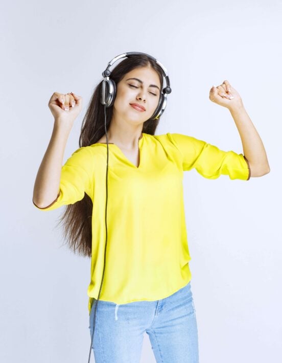 Young girl dressed in yellow dancing to Tamil songs