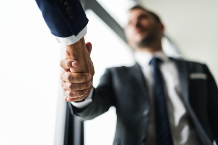 Businessmen shaking hands as they greet each other in Afrikaans