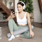 young-asian-woman-with-water-bottle-listening-music-podcast-headphones-during-fitness-home-min-150x150.jpg