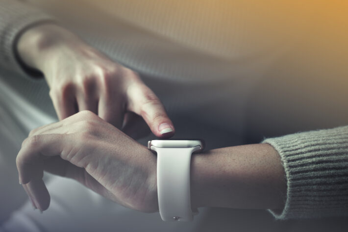 Image of a person checking the time on their watch